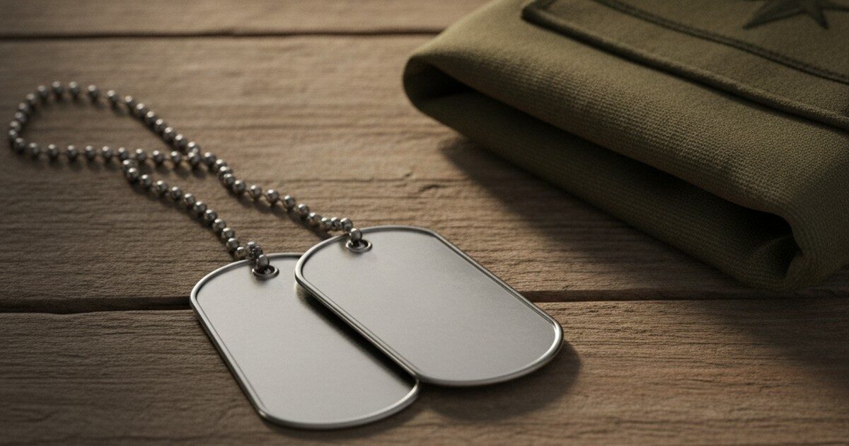 Blank military dog tags beside a folded uniform patch